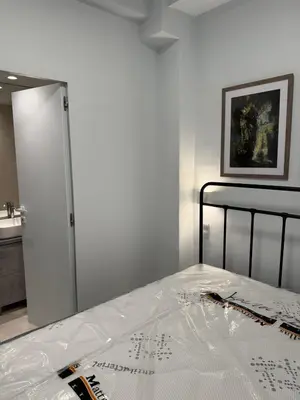 a bedroom with a bed with a white sheet on it at AMG Superior Central Apartment sleeps up to 5 in Athens