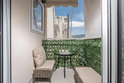a small balcony with a table and chairs at Quiet Escape Near Acropolis in Athens