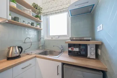 a small kitchen with a sink and a microwave at Quiet Escape Near Acropolis in Athens