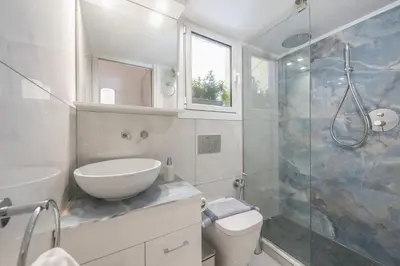 a bathroom with a sink and a toilet and a shower at Quiet Escape Near Acropolis in Athens