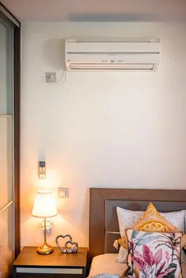 a bedroom with a bed with a air conditioner on the wall at Lovehome - 4BD Villa with views-15mins to airport,10mins to MEC ΑΕ- 2mins to bus stop ,10mins to Suburban Railway on foot in Athens
