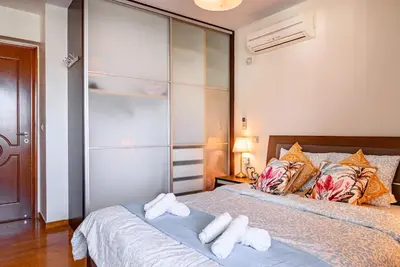 a bedroom with a bed with towels on it at Lovehome - 4BD Villa with views-15mins to airport,10mins to MEC ΑΕ- 2mins to bus stop ,10mins to Suburban Railway on foot in Athens