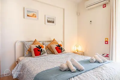 a bedroom with a bed with towels on it at Lovehome - 4BD Villa with views-15mins to airport,10mins to MEC ΑΕ- 2mins to bus stop ,10mins to Suburban Railway on foot in Athens