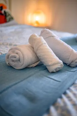 a towel is laying on top of a bed at Lovehome - 4BD Villa with views-15mins to airport,10mins to MEC ΑΕ- 2mins to bus stop ,10mins to Suburban Railway on foot in Athens