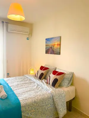 a bedroom with a bed and a painting on the wall at Lovehome - 4BD Villa with views-15mins to airport,10mins to MEC ΑΕ- 2mins to bus stop ,10mins to Suburban Railway on foot in Athens