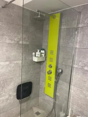 a shower with a yellow sign in a bathroom at Lovehome - 4BD Villa with views-15mins to airport,10mins to MEC ΑΕ- 2mins to bus stop ,10mins to Suburban Railway on foot in Athens