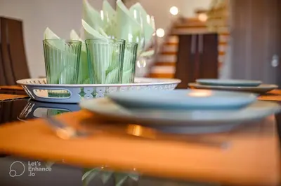 a table with plates and cups on top of it at Lovehome - 4BD Villa with views-15mins to airport,10mins to MEC ΑΕ- 2mins to bus stop ,10mins to Suburban Railway on foot in Athens