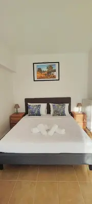 a bedroom with a large bed with white sheets at Zen Apartment in Athens