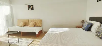 a room with a bed and a couch and a chair at Zen Apartment in Athens