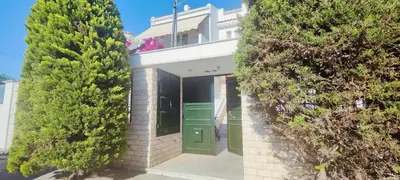 a building with a green door and some trees at Zen Apartment in Athens