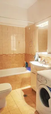 a bathroom with a sink and a washing machine at Zen Apartment in Athens