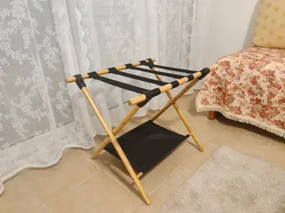 a wooden stand next to a chair next to a curtain at Zen Apartment in Athens