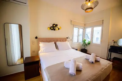 a bedroom with a large bed with towels on it at Acropolis Touch 7th Wonder View DG in Athens