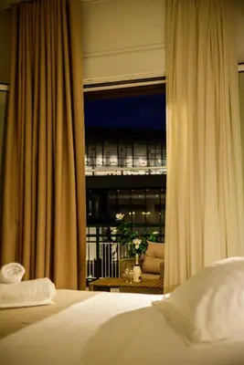 a bedroom with a window with a view of a balcony at Acropolis Touch 7th Wonder View DG in Athens
