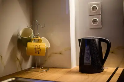 a toaster sitting on a wooden counter next to a cup at Acropolis Touch 7th Wonder View DG in Athens