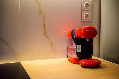 a red and black coffee maker sitting on a counter at Acropolis Touch 7th Wonder View DG in Athens