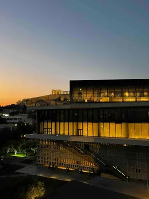 a building with a lit up facade at dusk at Acropolis Touch 7th Wonder View DG in Athens