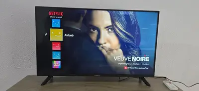a flat screen tv sitting on top of a table at Jasmine House in Athens
