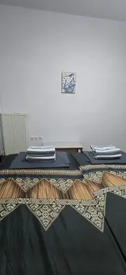 a room with a table with towels on top of it at Jasmine House in Athens