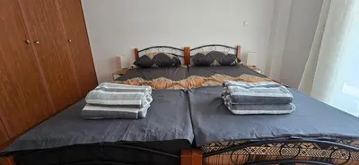 a bed with two pillows on top of it at Jasmine House in Athens