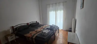a bedroom with a bed and a large window at Jasmine House in Athens