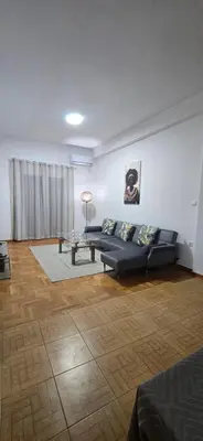 a living room with a couch and a table at Jasmine House in Athens