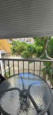 a glass table sitting on top of a balcony at Jasmine House in Athens