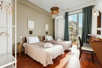 two beds in a room with a window at The Square Hotel by X&N in Athens