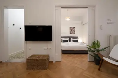 a bedroom with a bed and a tv in a room at Modern apartment near Lycabettus hill with balcony in Athens
