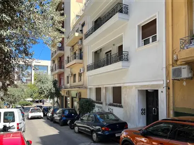 a city street with cars parked in front of buildings at Modern apartment near Lycabettus hill with balcony in Athens
