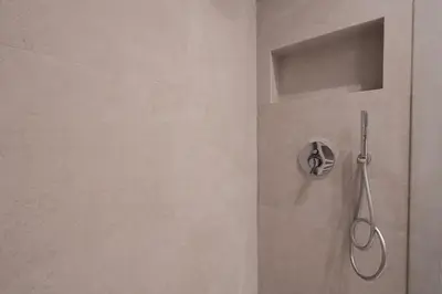 a shower with a shower head in a bathroom at Modern apartment near Lycabettus hill with balcony in Athens