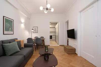 a living room with a couch and a table at Modern apartment near Lycabettus hill with balcony in Athens