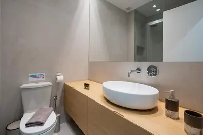 a bathroom with a white sink and a toilet at Modern apartment near Lycabettus hill with balcony in Athens