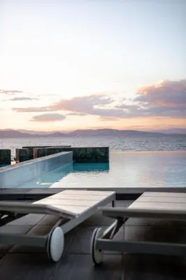 a swimming pool with the ocean in the background at Horizon Luxury Seafront Villa in Vaia