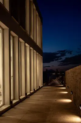 an empty hallway of a building at night at Horizon Luxury Seafront Villa in Vaia