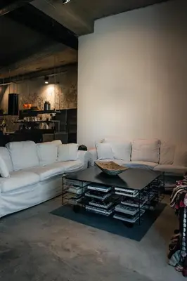 a living room with a white couch and a table at Horizon Luxury Seafront Villa in Vaia