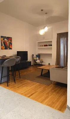 a living room with a couch and a table at The Blue Apartment in Athens