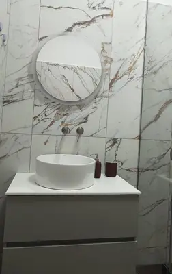 a bathroom with a white sink and a mirror at The Blue Apartment in Athens