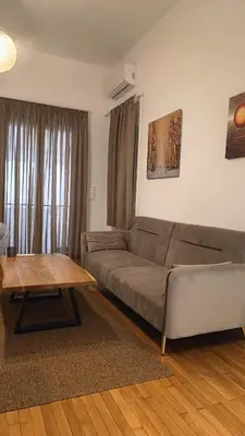 a living room with a couch and a coffee table at The Blue Apartment in Athens