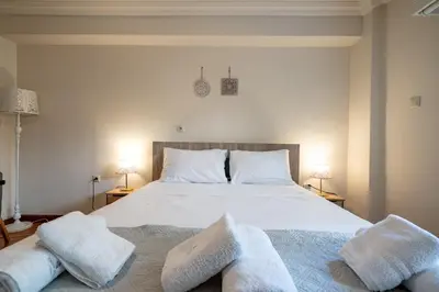 a bedroom with a large white bed with two pillows at Downtown Kolonaki Getaway - 1BR Apartment by ΜΡS in Athens