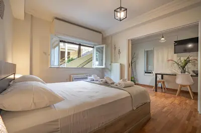 a bedroom with a large white bed and a desk at Downtown Kolonaki Getaway - 1BR Apartment by ΜΡS in Athens