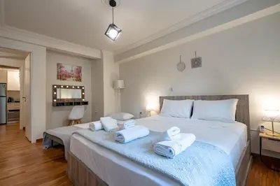 a bedroom with a large white bed with towels on it at Downtown Kolonaki Getaway - 1BR Apartment by ΜΡS in Athens