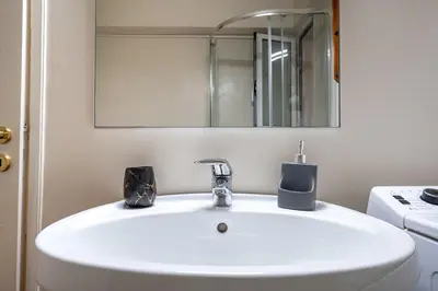 a white sink in a bathroom with a mirror at Downtown Kolonaki Getaway - 1BR Apartment by ΜΡS in Athens