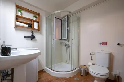 a bathroom with a shower and a toilet and a sink at Downtown Kolonaki Getaway - 1BR Apartment by ΜΡS in Athens