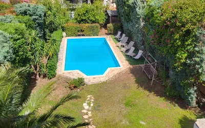 an overhead view of a swimming pool in a garden at Luxury villa El Verano with private pool in Kalívia Thorikoú