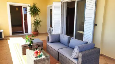 a living room with a couch and a table at Luxury villa El Verano with private pool in Kalívia Thorikoú