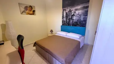 a bedroom with a bed and a painting on the wall at Luxury villa El Verano with private pool in Kalívia Thorikoú