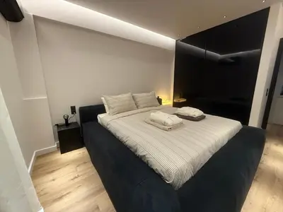 a bedroom with a bed with two towels on it at Πολυτελής απόδραση στην Γλυφάδα in Athens