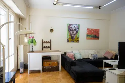 a living room with a black couch and a table at La Boheme stylish Flat i in Athens