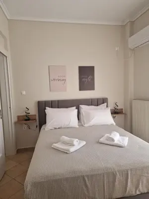 a bedroom with a bed with two towels on it at The Argy Apartment in Athens